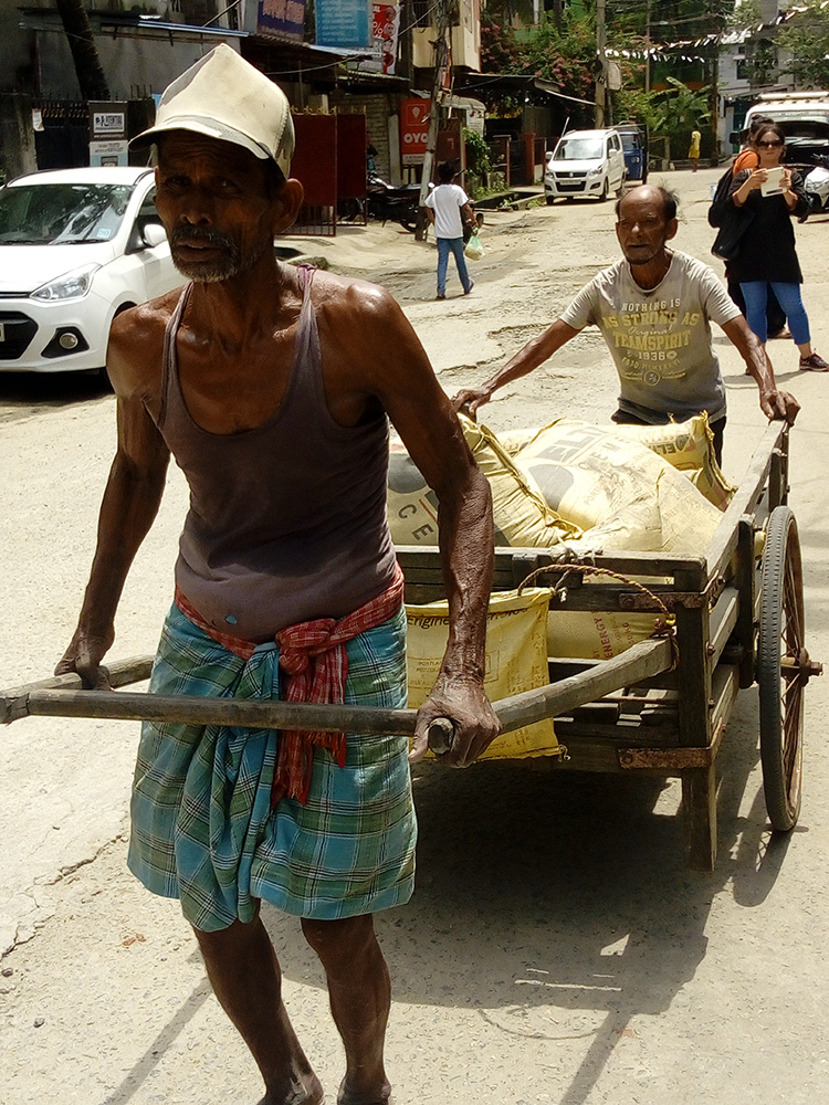 Cart-pullers-carrying-building-materials,-Guwahati